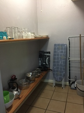 Apartment D, Pantry with cooking utensils and cleaning items